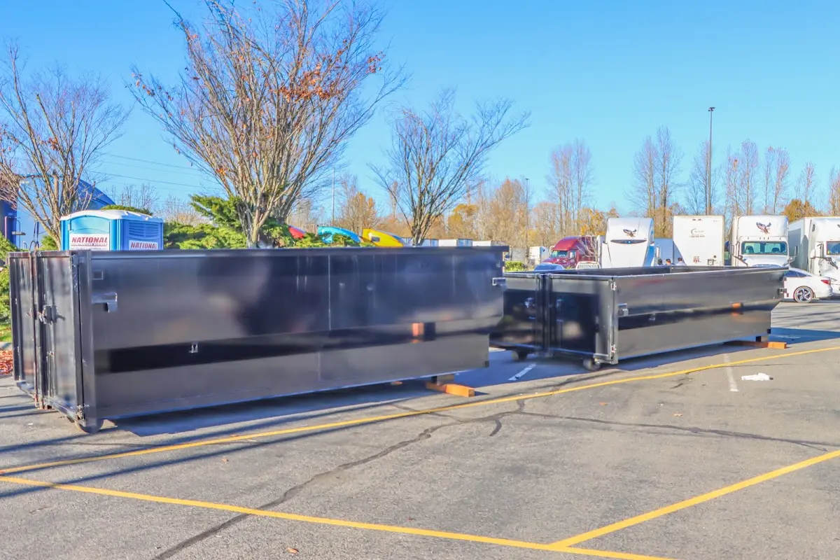 Professional dumpster rental service with roll-off container on residential driveway in Molalla